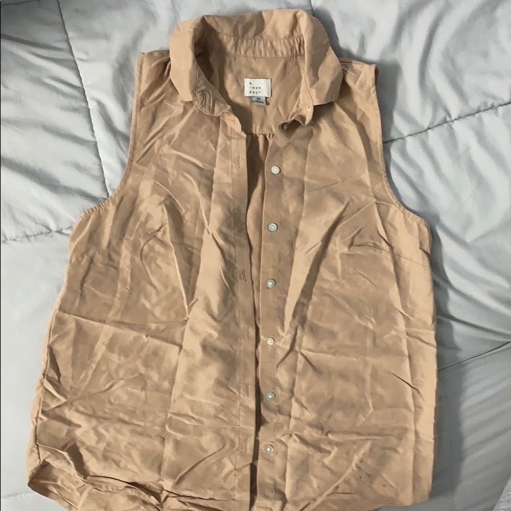 beige sleeveless button up shirt